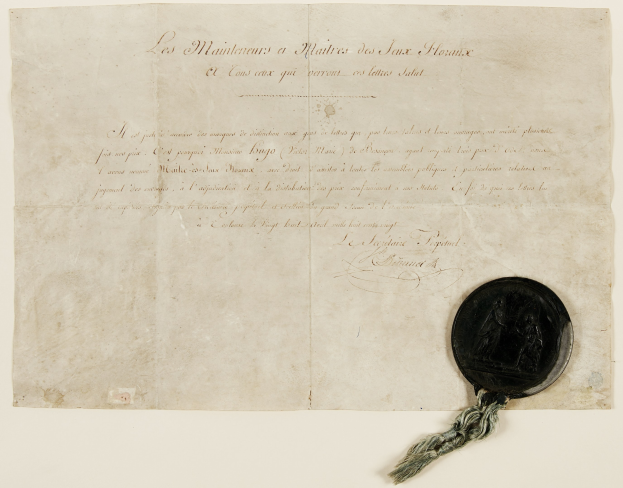 Alter Dokument mit Wachssiegel, wahrscheinlich ein Vertrag, mit Text und einem Wachsstempel.