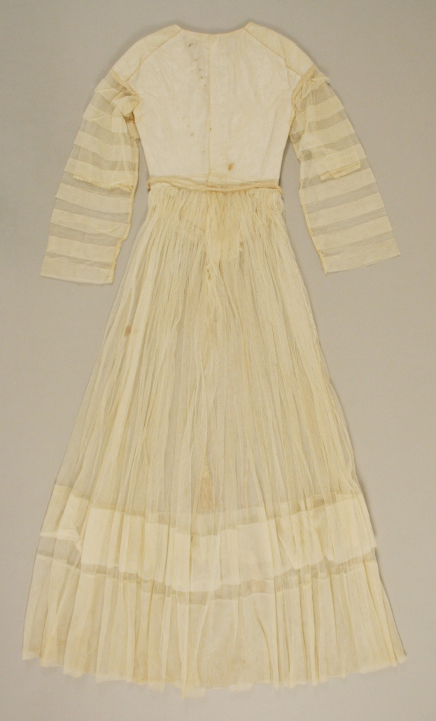 Weißes Kleid mit langen Ärmeln und einer gerafften, bodenlangen Schleppe auf einer weißen Oberfläche, mit hohem Bund, voluminösem Stoff und dezentem Glanz.