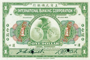 Alte Ein-Dollar-Banknote der International Banking Corporation mit grün-weißem Farbschema, die "International Banking Corporation" in fetter schwarzer Schrift oben und eine Globus-Illustration in der Mitte zeigt.