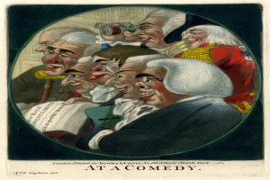 Eine Gruppe von Menschen, die in einem Kreis stehen, einer hält ein Blatt Papier in der Hand und lacht bei einer Comedy-Veranstaltung.