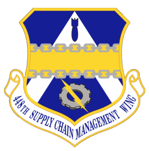 Logo des 48. Versorgungsgeschwader mit einem blauen Schild mit einem weißen Stern und einem weißen Banner mit der Aufschrift "Versorgungsgeschwader" in blau, alles von einem weißen Rand umgeben und mit der Schrift "48. Versorgungsgeschwader" in fetter schwarzer Schrift.